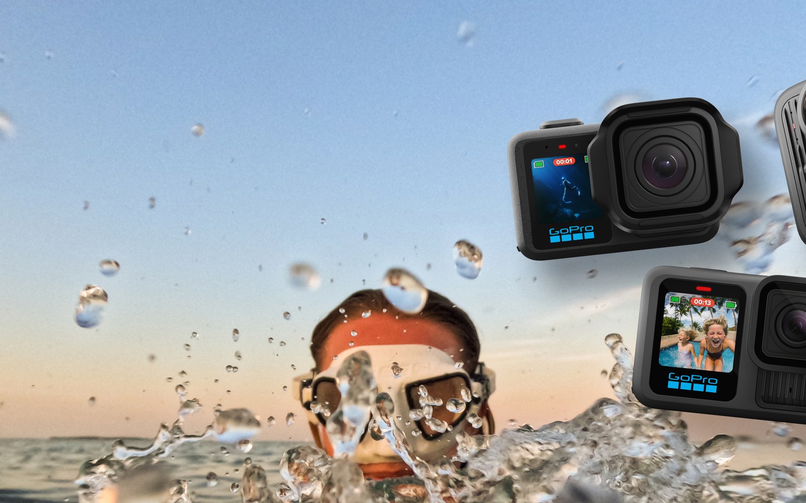 A swimmer wearing goggles surfaces amid splashing water beside two GoPro action cameras